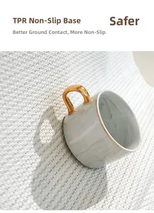 Close-up of the non-slip TPR bottom of a luxury marble pattern ceramic mug with gold handle