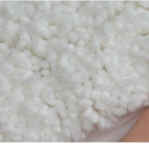 Close-up of soft white plush fiber filling with fluffy texture for Christmas bath mat