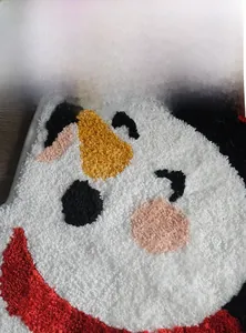 Detailed close-up of thick high-density Christmas snowman rug fibers and texture