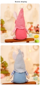 Rear view of pink and blue knit Easter gnomes with plaid aprons on a wooden bench