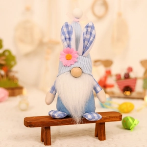 Easter gnome plush doll with rabbit ears and blue knitted hat sitting on wooden bench