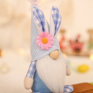 Handcrafted Easter gnome doll with light blue knit hat, bunny ears and floral decoration
