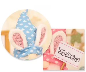 Detail display of glowing Easter gnomes with rabbit ears and Welcome wooden sign