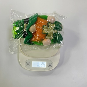 Weight measurement of a St. Patrick's Day plush gnome with green sequined hat and clover