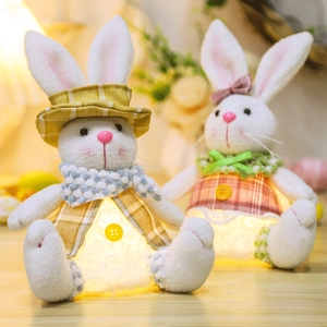 Close-up of glowing plush Easter bunnies with warm lace lighting and soft fabric details