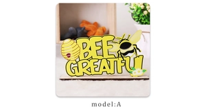 Detail of Bee Grateful painted wood desk ornament with cartoon bee and daisy patterns