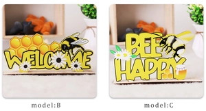 Detail of wooden Bee Happy and Welcome tabletop ornaments with festive honeybee patterns