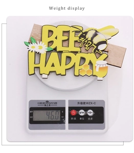 Detailed view of Bee Happy wooden sign on digital scale weighing 46.0g for decor