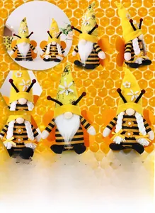 Detailed view of bee gnome plush toys featuring fuzzy wings and sunflower accents
