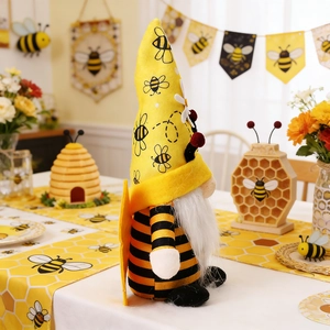 Detailed close-up of handmade bee gnomes with striped wings for festive table decor