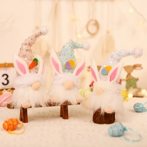 Three Easter gnomes with sequins hats and rabbit ears lit by soft decorative string lights