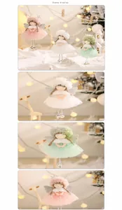 Detail of plush angel ornaments with tulle skirts and bells in festive holiday setting