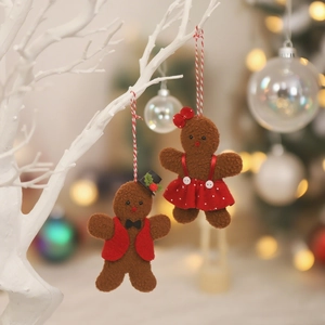 Christmas gingerbread man plush ornaments with red vest and polka dot dress on white branch