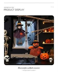 Halloween burlap witch and pumpkin plush ornaments hanging on branches with spooky background