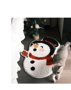 Macro detail of plush snowman rug with red scarf and carrot nose on dark wood floor