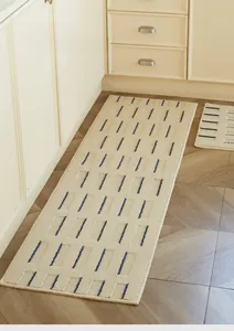 Detail of cream kitchen mat showing waffle texture and blue dashed patterns
