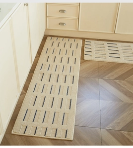 Detail of cream kitchen floor mats with blue stripes on wood floor, anti-slip texture