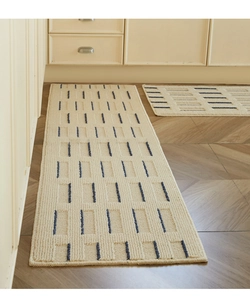 Detail of cream kitchen floor mat set with textured weave and geometric pattern