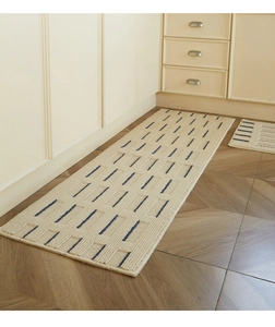 Close-up of cream kitchen mat with blue dash lines and non-slip woven texture