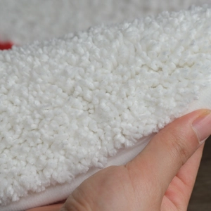 Thick plush snowman bath mat with non-slip backing showing soft texture and thickness