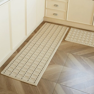 Creamy beige non-slip kitchen mat set with brown grid pattern on wooden floor