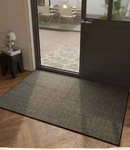 Detail of a minimalist striped entrance doormat on wooden floor with garden background