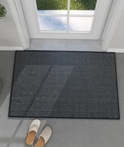 Close-up of a blue entry mat with white stripes and high-quality woven texture