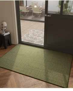 Close-up of moss green indoor doormat with textured ridges and durable edges