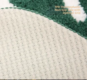 Detail of the non-slip TPR backing with star patterns on the green Christmas floor mat