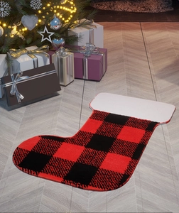 Detail of Christmas stocking bath mat with red buffalo plaid pattern on wood floor