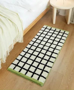 Detail of Bauhaus grid rug with thick plush texture and vibrant green stitched edges