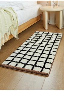 Macro view of checkered tufted rug with soft plush texture and durable brown hemmed edges