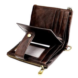 Detail of vintage brown leather wallet with card slots and a clear ID window