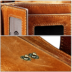 Detail of vintage brown leather wallet with RFID blocking slots and metal snap button