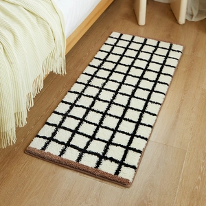 Thick checkered Bauhaus rug on light wood floor for bedroom bedside decor