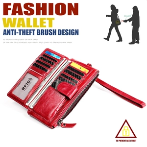 Detail view of red leather wallet featuring RFID blocking slots and a wrist strap