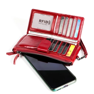 Detail view of red leather wallet interior with RFID card slots and smartphone compartment