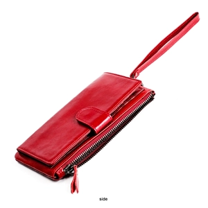 Side view of dark red leather long wallet with zipper compartments and wrist strap