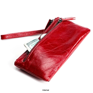 Detail view of red genuine leather wallet interior showing banknote compartments and wristlet