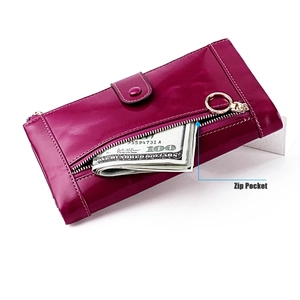 Detail of a vintage purple leather wallet with a zip pocket and metal ring accent