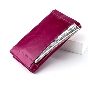 Detail of rose red leather wallet featuring white contrast stitching and a side zipper