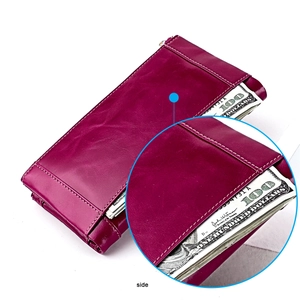 Detail view of magenta vintage leather long wallet featuring external side pocket for bills
