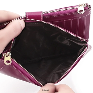 Internal detail of a vintage leather wallet showing deep purple finish and neat stitching