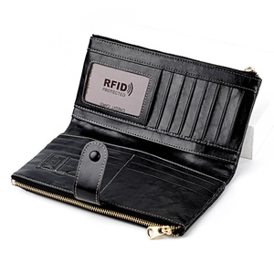 Detail view of the RFID-protected slots and golden zipper in the black leather wallet