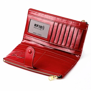 Detailed interior of red leather wallet showing multiple card slots and RFID protection card
