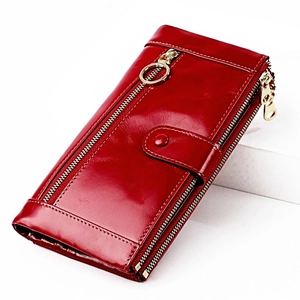 Detail view of red oil wax leather long wallet with dual zippers and gold hardware