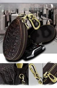 Detail view of vintage dark brown oil wax leather car key case with embossed alligator pattern
