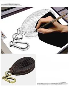 Detailed view of brown litchi grain leather car key pouch with vintage brass hook