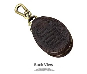 Detail view of the dark brown leather car key pouch showing the crocodile pattern back