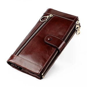 Detail of dark brown oil wax leather wallet featuring multi-zipper and gold hardware